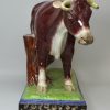 Oversize Staffordshire pearlware pottery cow decorated with overglaze enamels, circa 1820