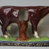 Oversize Staffordshire pearlware pottery cow decorated with overglaze enamels, circa 1820