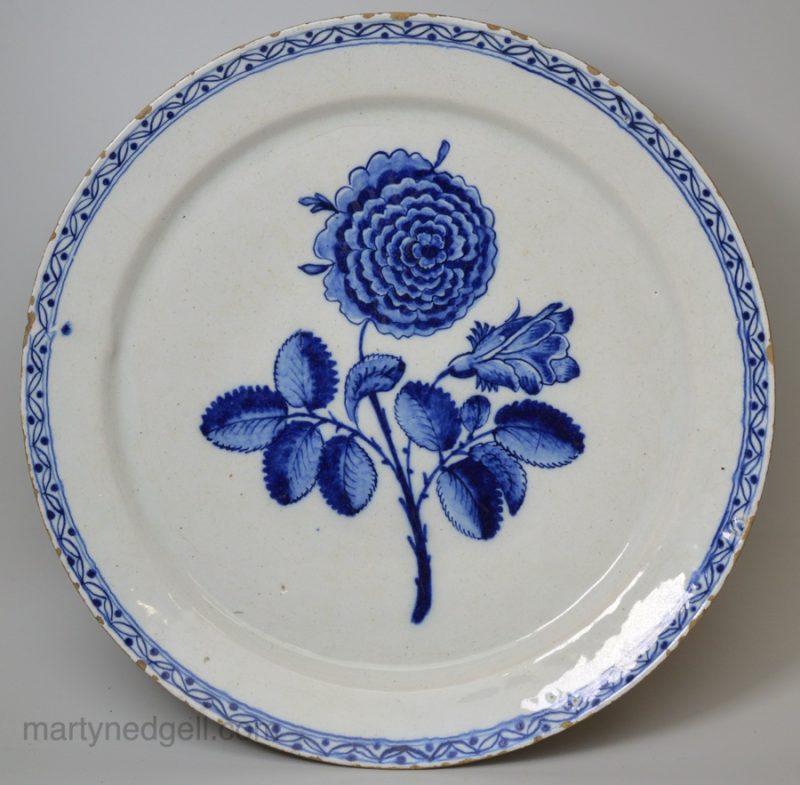 London delft charger painted in blue with a rose, circa 1760