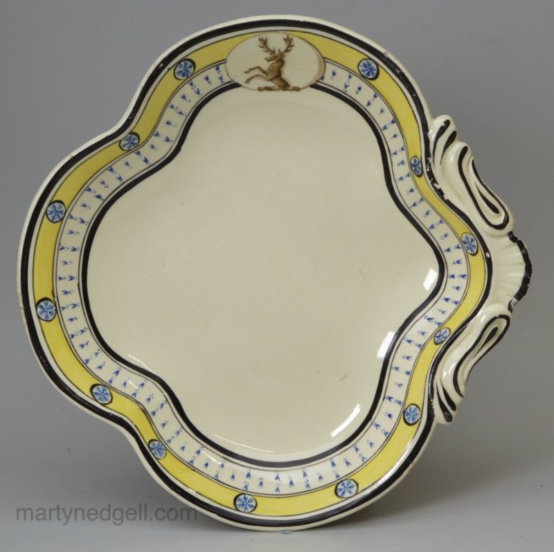 Creamware pottery dessert dish decorated with a family crest, circa 1800, one of two