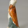 Pearlware pottery figure of a woman decorated with colours under the glaze, circa 1800