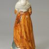 Pearlware pottery figure of a woman decorated with colours under the glaze, circa 1800