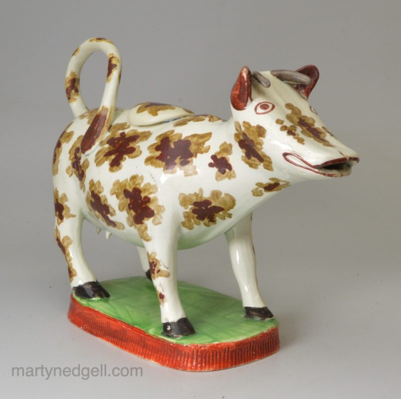 Pearlware pottery cow creamer decorated with overglaze enamels, circa 1820