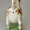 Pearlware pottery cow creamer decorated with overglaze enamels, circa 1820