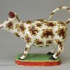 Pearlware pottery cow creamer decorated with overglaze enamels, circa 1820