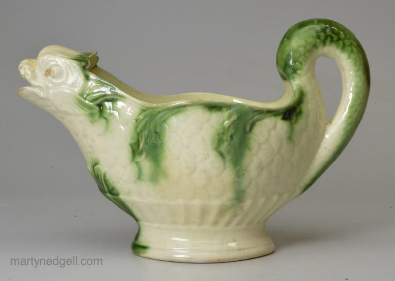 Creamware pottery dolphin sauce boat decorated with green under the glaze, circa 1780