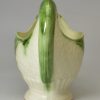 Creamware pottery dolphin sauce boat decorated with green under the glaze, circa 1780