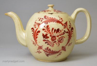 Creamware pottery teapot decorated with red enamel over the glaze, circa 1770