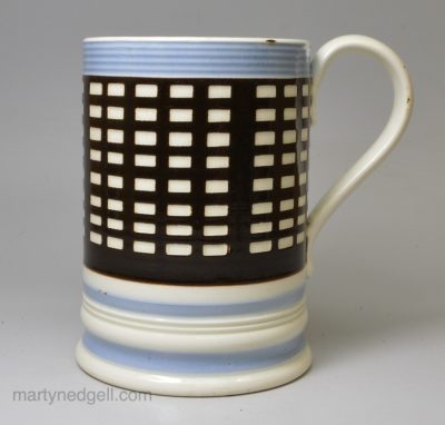 Mochaware mug decorated with brown slip engine turned to reveal the pearlware pottery below, circa 1830