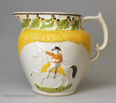 Commemorative pearlware pottery jug moulded with General Wellington and decorated with colours under the glaze, circa 1810