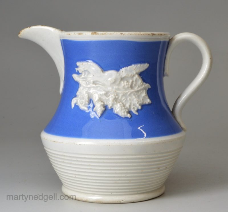 Small pearlware jug decorated with blue slip and sprigs, circa 1830