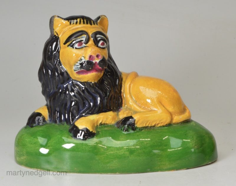 Pearlware pottery lion decorated with colours under the glaze, circa 1820 possibly Scottish Pottery