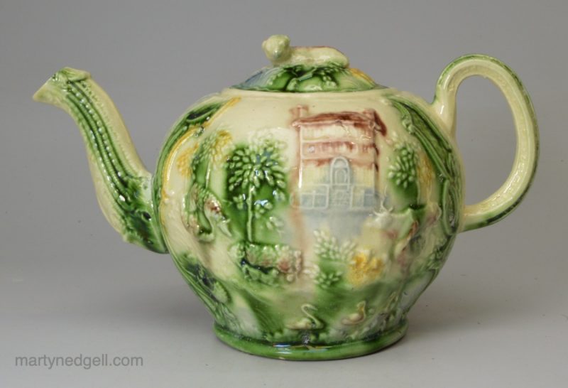 Creamware p[ottery teapot moulded with the Landskip pattern and coloured under the glaze, circa 1770