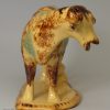 Buff coloured pottery cow creamer decorated with colours under the glaze, circa 1860