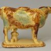 Buff coloured pottery cow creamer decorated with colours under the glaze, circa 1860