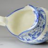 Pearlware pottery cream jug decorated with a blue transfer print under the glaze, circa 1820