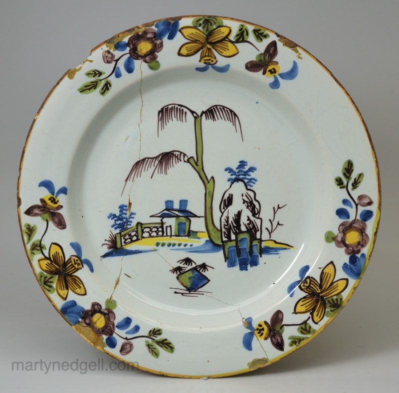 London delft polychrome plate with a daffodil border, circa 1750