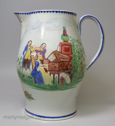 Large pearlware jug decorated with musicians at play with enamels over the glaze, circa 1800