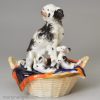 Staffordshire porcelain group of a spaniel and pups in a basket, circa 1840