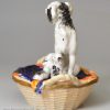 Staffordshire porcelain group of a spaniel and pups in a basket, circa 1840