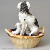 Staffordshire porcelain group of a spaniel and pups in a basket, circa 1840