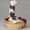 Staffordshire porcelain group of a spaniel and pups in a basket, circa 1840