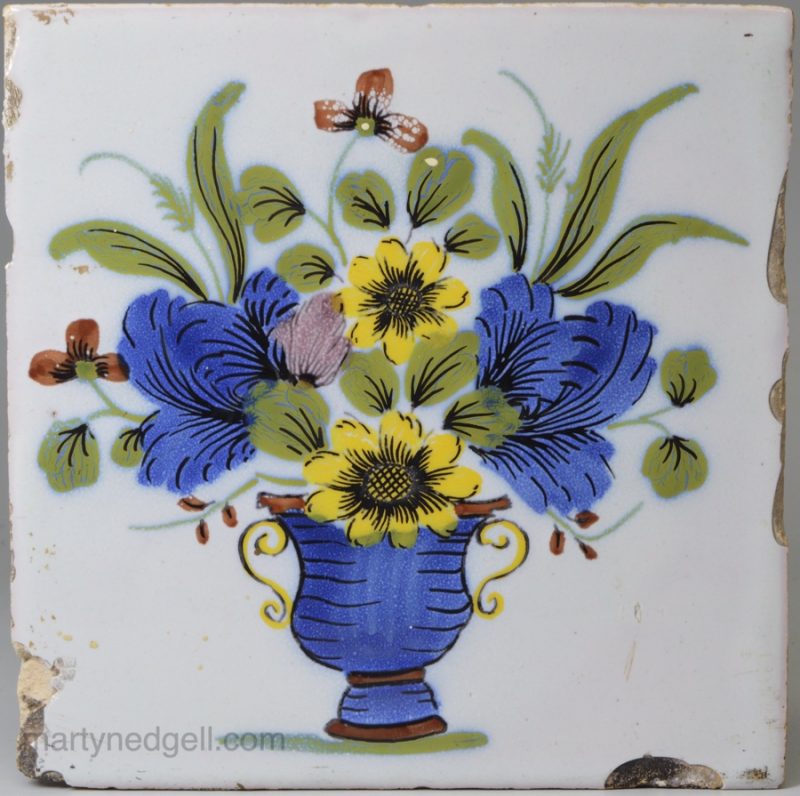 Liverpool delft tile painted in the fazackerly style with a vase of flowers, circa 1750