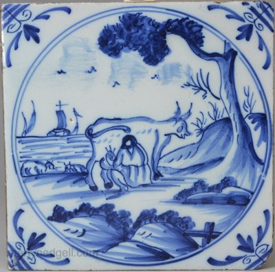 London delft tile painted in blue with a cow being milked, circa 1740