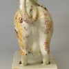 Pearlware pottery cow creamer decorated with colours under the glaze, circa 1820