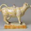 Pearlware pottery cow creamer decorated with colours under the glaze, circa 1820