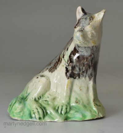 Pearlware pottery dog decorated with colours under the glaze, circa 1790