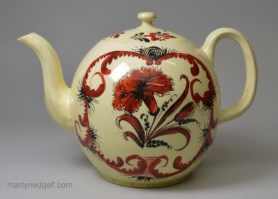 Creamware pottery teapot decorated with red and black enamels over the glaze, circa 1770, possibly Cockpit Hill Pottery