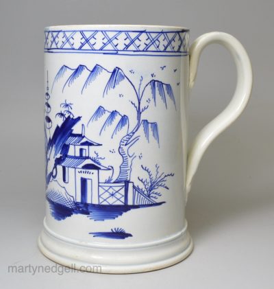 Pearlware pottery quart mug decorated in blue under the glaze, circa 1800