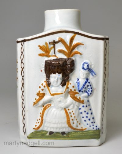 Prattware pottery tea canister moulded with Macaroni figures, circa 1820