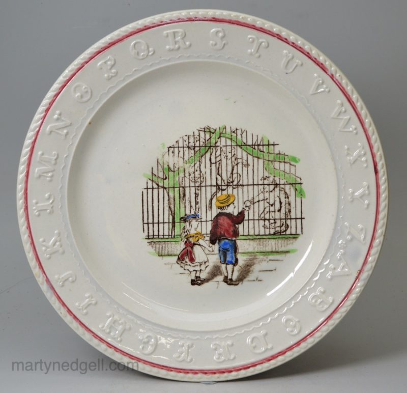 Pearlware pottery Child's alphabet plate printed with children feeding monkeys at the zoo, circa 1840