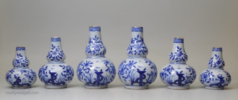 A garniture of six small Liverpool delft vases, circa 1760