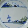 London delft pancake plate painted in blue, green and dark manganese, circa 1740