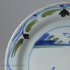 London delft pancake plate painted in blue, green and dark manganese, circa 1740