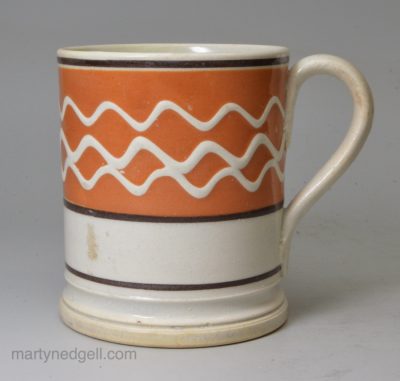 Small mocha ware mug decorated with slip over a pearlware glaze, circa 1830