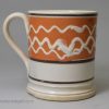 Small mocha ware mug decorated with slip over a pearlware glaze, circa 1830