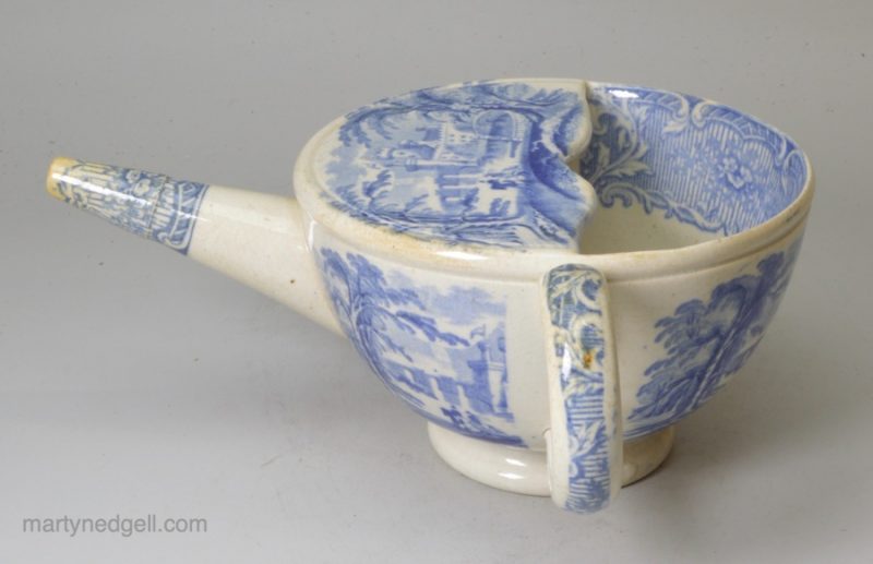 Pearlware pottery feeding cup decorated with a blue transfer under the glaze, circa 1840