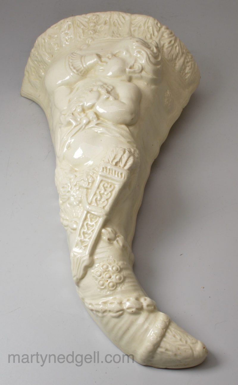 Creamware pottery wall pocket moulded with a Bacchanalian boy, circa 1770