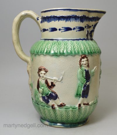 Pearlware pottery jug moulded with the Parson, Clerk and Sexton, and decorated with blue and green under the glaze, circa 1790, possibly Wood Family