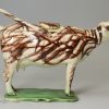 Pearlware pottery cow creamer decorated with colours under the glaze, circa 1810