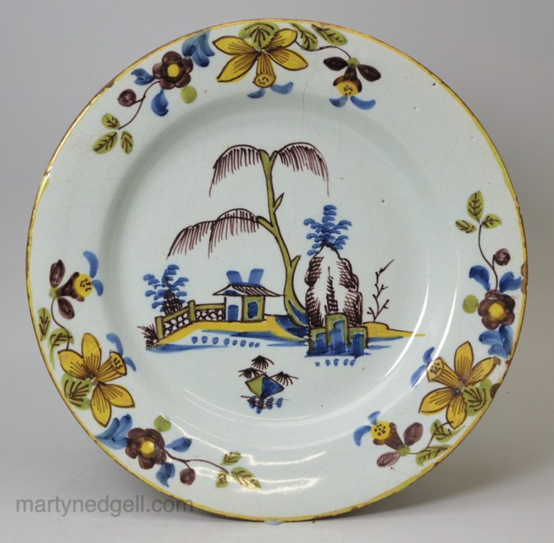 London delft polychrome plate with daffodil border, circa 1740