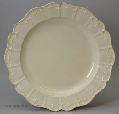 Creamware pottery dinner plate with a moulded border, circa 1780