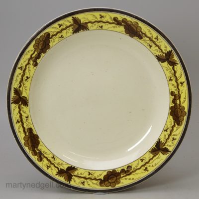 Small creamware plate decorated with a painted border, circa 1790