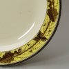 Small creamware plate decorated with a painted border, circa 1790