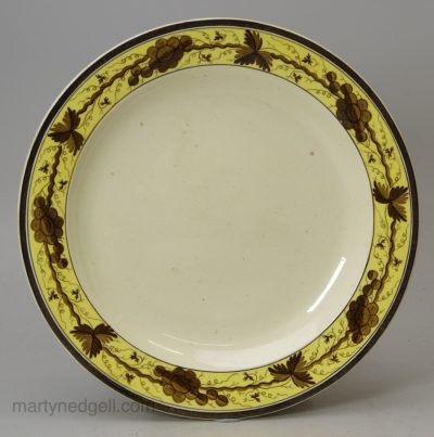 Small creamware plate decorated with a painted border, circa 1790