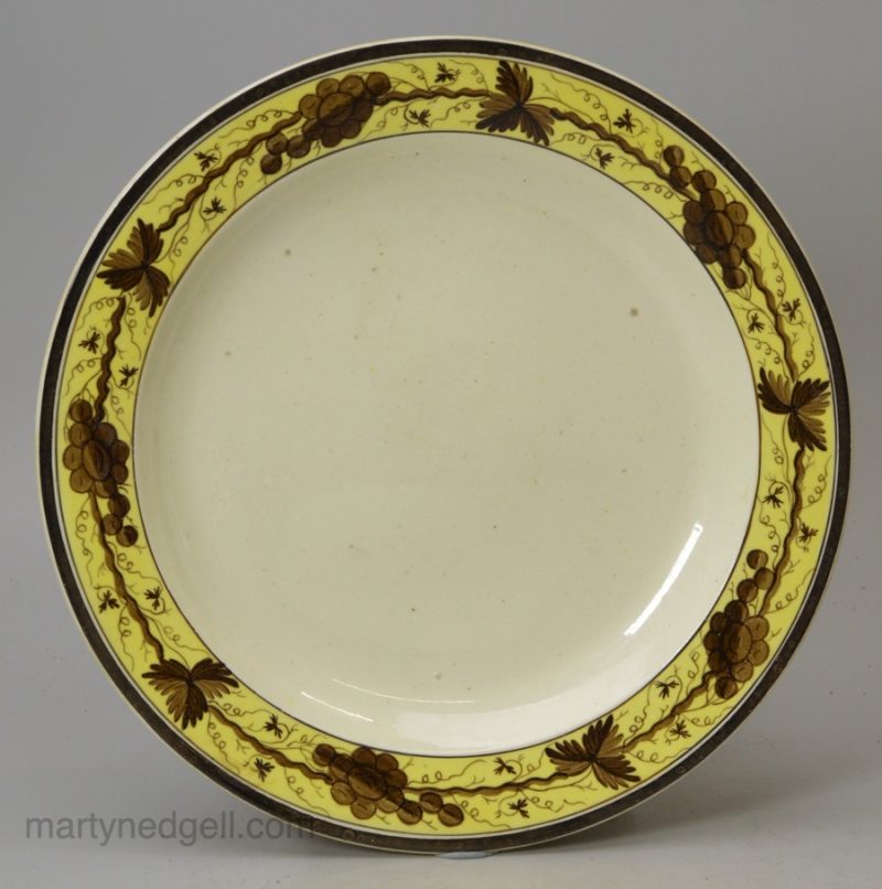 Small creamware plate decorated with a painted border, circa 1790